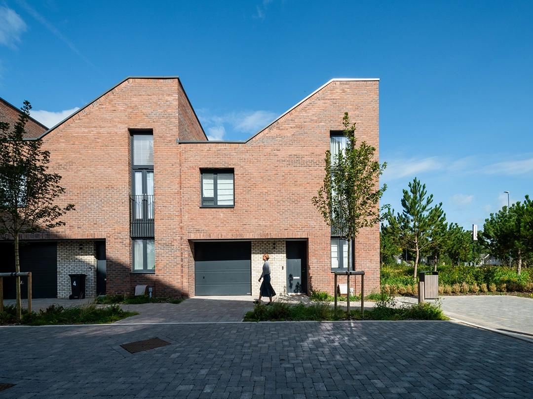 Woman walking on a sunny day via tree lined Frise Street at Brabazon.
