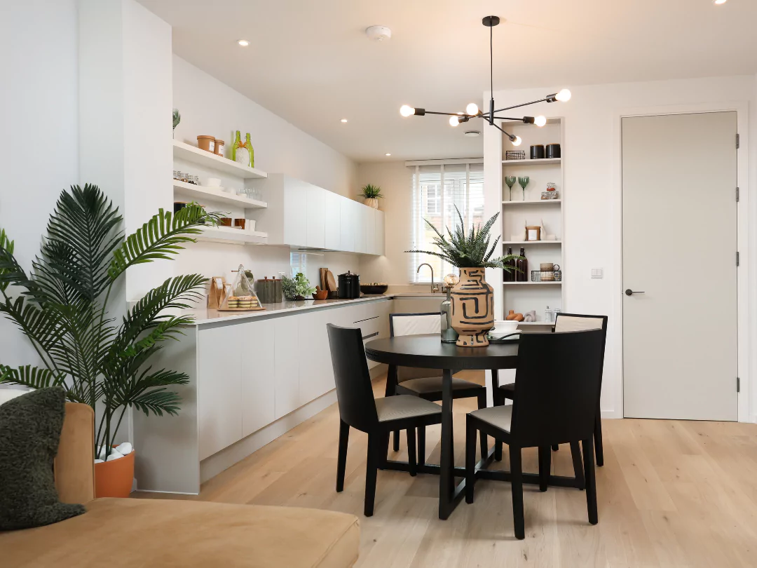 Open-plan kitchen diner with glossy white work tops, ample storage and stylish extras.