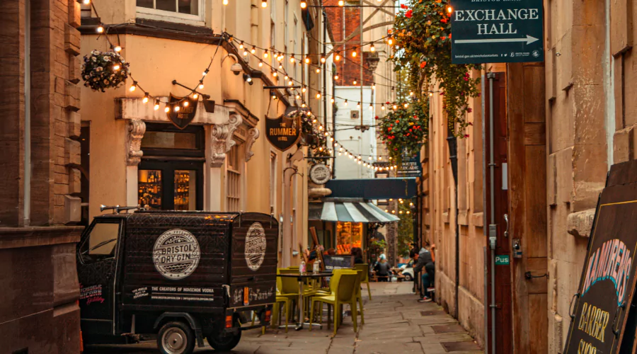 Entrance to St Nicholas Market featuring string outdoor lights and a paved alleyway.