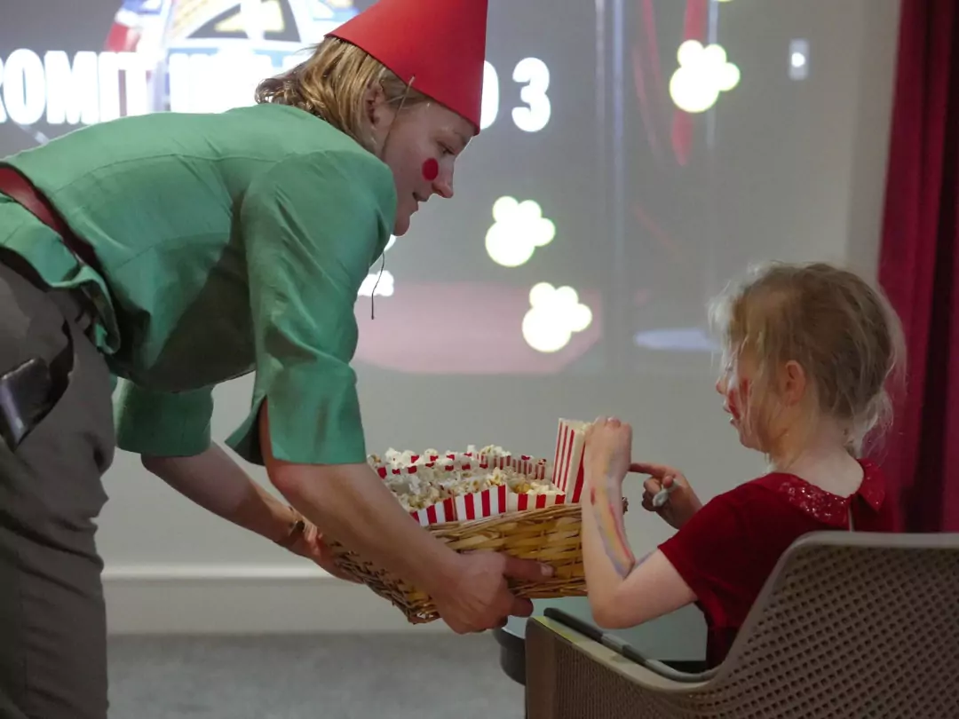 Southern Brooks Community Development Worker handing out popcorn at the Wallace & Gromit film screening, in celebration of Gromit Unleashed 3 at Brabazon, Bristol. 
