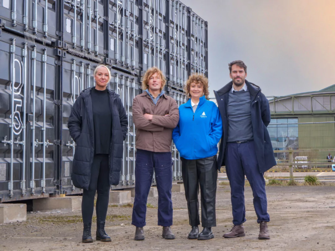 Four people standing together outside the Boxworks site that has relocated to Brabazon .