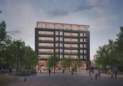 Night-time scene of people walking through a lit, landscaped pedestrian square with a modern office building in the background.