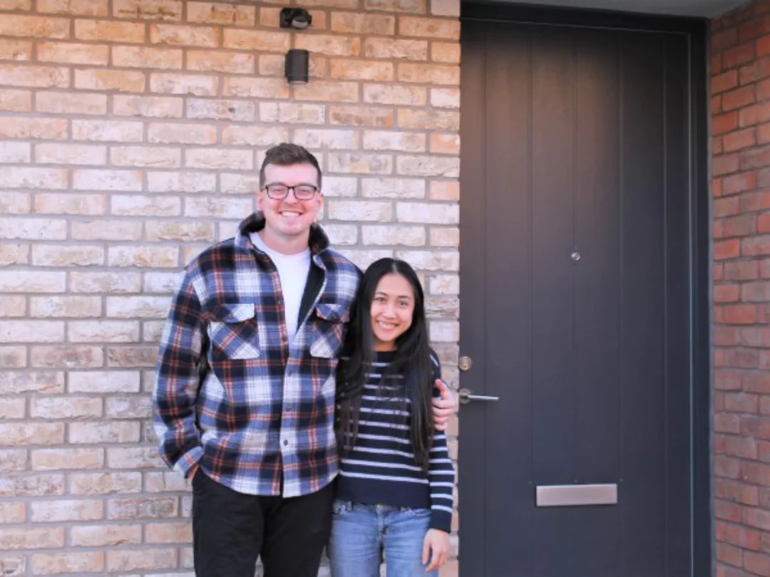 Image of two Brabazon residents, Tom and Tammie, smiling and standing outside their home.