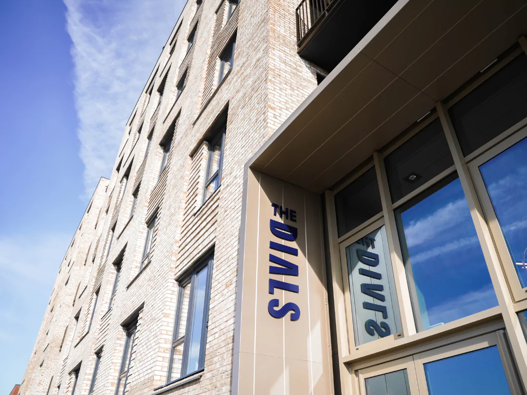 The Dials sign on the front facade of The Dials apartment building.