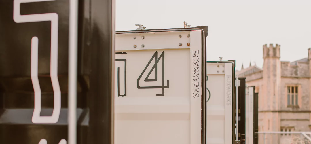 Row of black and white Boxworks container offices. 
